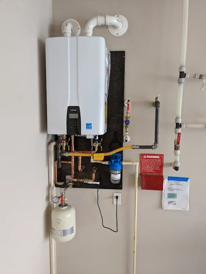 Professional plumber installing copper piping in a Maryville home